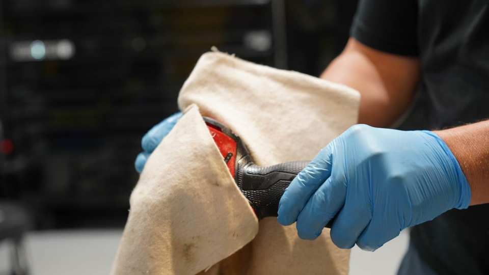 Technicus veegt elektrisch gereedschap af met een Green Boom-mat